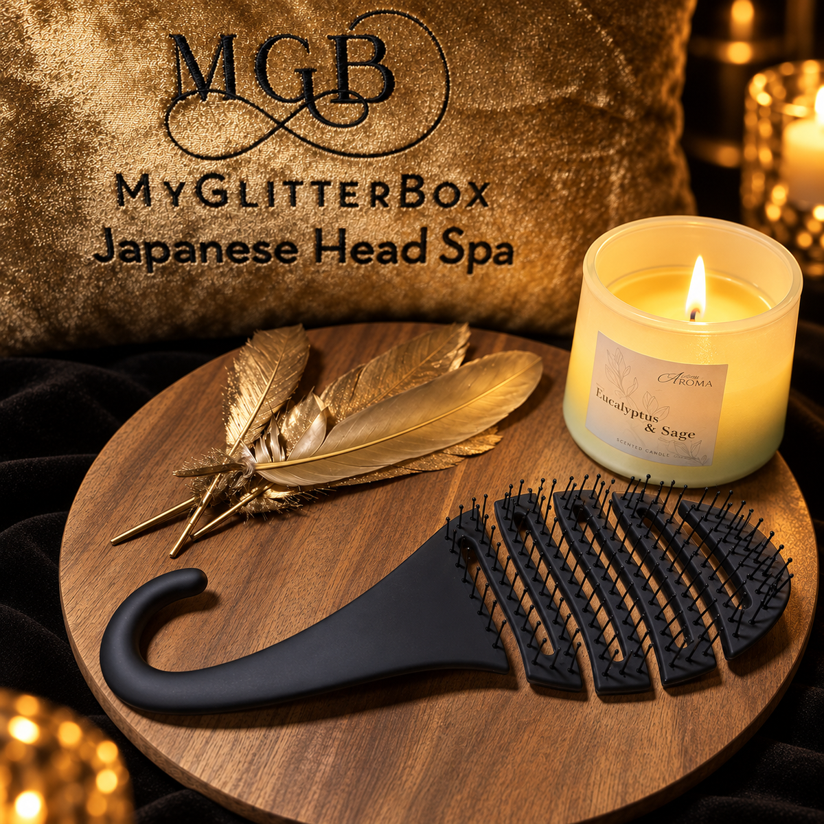Black flexible vented hairbrush displayed with gold feathers and a candle at GlitterBox Head Spa in Stafford.